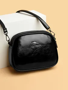 Classic black oil-wax leather crossbody bag with triple compartments and gold kangaroo logo