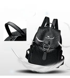 Detail of black soft leather backpack featuring woven texture and metallic kangaroo emblem