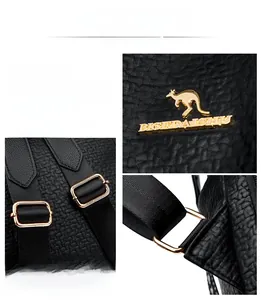 Detailed macro view of golden metal hardware and branding on lychee pattern leather bag