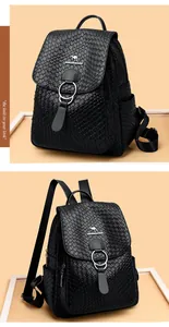 Detail of black textured soft leather backpack with kangaroo logo and metal ring buckles