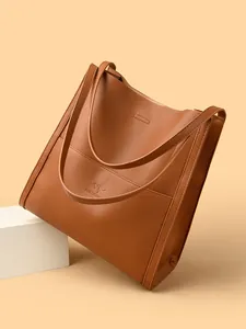 Brown embossed leather tote bag with kangaroo logo on elegant geometric display