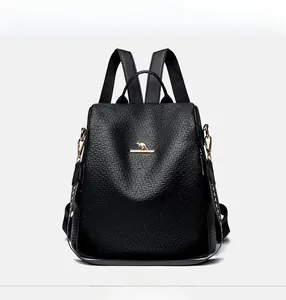 Close-up of black litchi pattern leather backpack with golden kangaroo logo and metal hooks