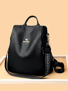 Black leather backpack with gold kangaroo logo and jacquard strap on beige background