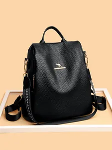 Black leather backpack for women with kangaroo logo and gold zippers in a soft studio setting