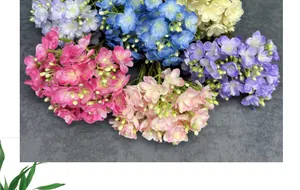 Macro view of colorful silk jasmine bouquets showing detailed fabric petals and green buds