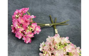 Macro shot of faux pink jasmine bouquets with realistic petals and tied brown stems