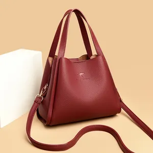 Classic burgundy pebbled leather kangaroo bucket bag with dual handles and gold strap