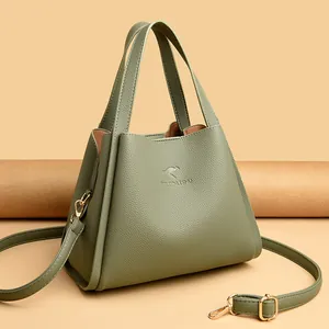 Grass green lychee leather bucket bag with top handles and adjustable shoulder strap