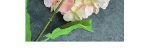 Close-up of light pink and cream faux hydrangea petals with detailed fabric texture