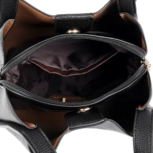 Black pebbled leather bucket bag with brown interior and golden zip compartments