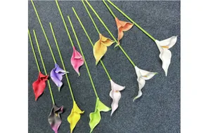 Detail showing various colors of EVA artificial calla lilies on textured grey fabric