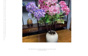 Detail of realistic pink and purple silk hydrangea flowers in a ceramic vase for home decor