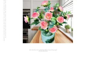 Pink artificial rose bouquet in a classic ceramic pot on a wooden kitchen counter
