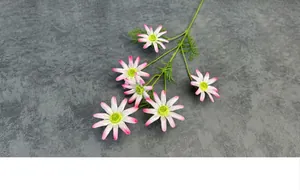Close-up of artificial daisy with pink gradient petals and realistic green leaves