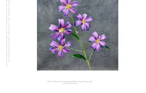 Macro detail of artificial lily with five purple striped flower heads and green leaves