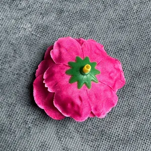 Top view of a bright rose pink artificial peony flower head with velvet texture petals
