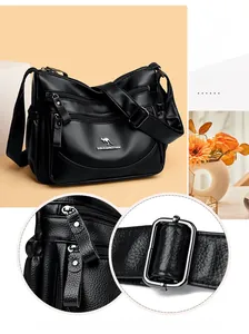 Close-up of black litchi pattern leather bag with multi-pocket zippers and metal buckles