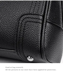 Macro detail of high-quality lychee grain leather handbag with silver protective metal feet