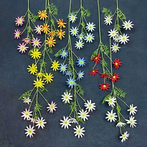 Vertical arrangement of colorful multi-head artificial silk daisies on a dark background