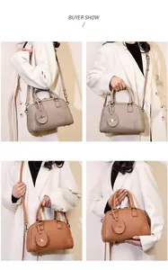 Multiple views of taupe and brown litchi leather dome boston bags shown on a model
