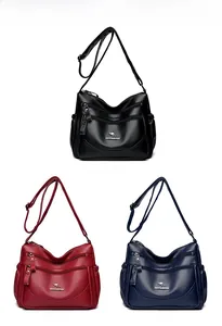 Multi-compartment leather shoulder bags in black, red, and blue with adjustable straps