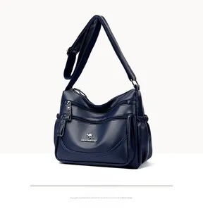 Macro shot of blue pebbled leather handbag with triple front zippers and silver kangaroo logo