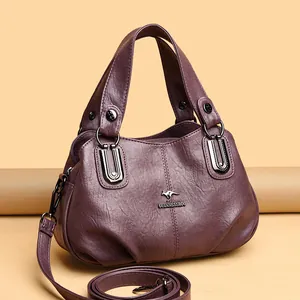 Elegant deep purple pebbled leather handbag with kangaroo logo and adjustable strap