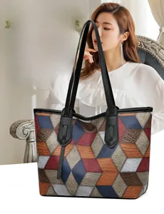 Close-up of color-block tote bag with geometric faux leather texture and crocodile pattern