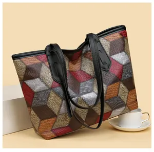 Detail of multi-color geometric tote bag with textured crocodile pattern and dual straps