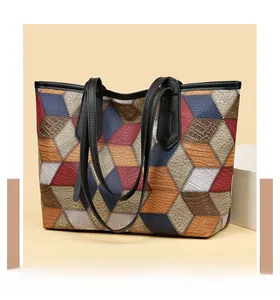 Detail of color-block tote bag featuring mixed textures like lychee and crocodile patterns