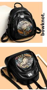 Detail of colorful elephant relief and vintage leather texture on black backpack