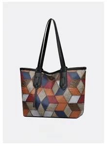Close-up of color-block tote bag featuring 3D geometric patterns and crocodile texture