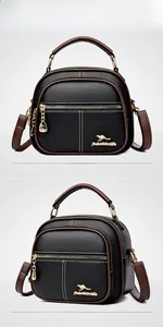 Close-up of litchi pattern leather bag with gold kangaroo logo and chain pendant