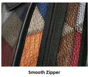 Detail of smooth metal zipper on high-quality multi-color pebbled leather tote bag