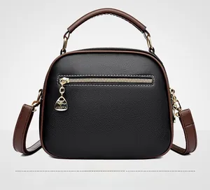 Close-up of contrast trim, metal zipper, and textured lychee leather on bag back