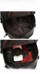 Detail view of the black leather backpack interior with main pocket and compartment