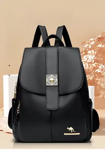 Detail of black pebbled leather backpack showing flap closure and metallic kangaroo logo