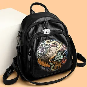 Black leather backpack featuring colorful elephant embossed relief and dual zippers