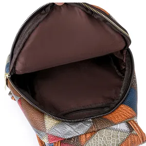Spacious interior of color-block leather chest bag showing fabric lining and zipper pocket