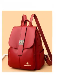 Detail of red lychee pattern leather backpack with gold metal turn-lock and brand logo