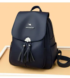 Detail of navy blue PU leather backpack with silver kangaroo logo and tassel charms