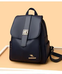 Detail of navy blue pebble leather backpack with gold geometric clasp and kangaroo logo