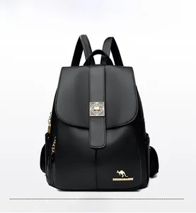 Front detail of black leather backpack with silver buckle and lychee grain texture