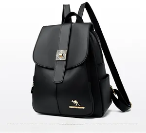 Detailed view of black pebbled leather texture and gold hardware on a casual backpack