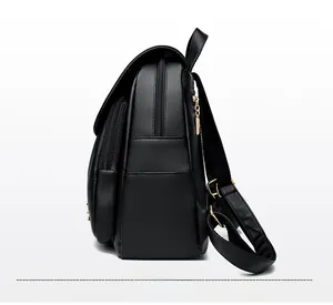 Side view of black lychee grain backpack with gold hardware and layered zipper detail