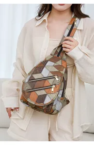Detail of geometric patchwork chest bag featuring brown and orange leather texture
