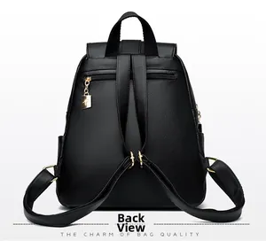 Detailed back view of black grained leather backpack with gold hardware and zipper pocket