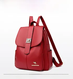 Detail of red leather backpack featuring pebble texture and gold kangaroo logo