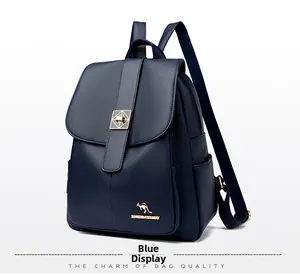 Detail view of the navy blue textured leather backpack with a gold kangaroo logo buckle