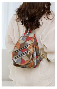 Detail view of colorful geometric patchwork texture on a versatile crossbody sling bag